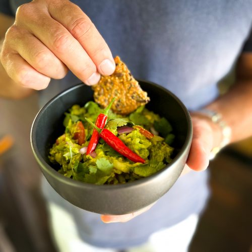 Bowl of Guacamole served with a paprika and chilli cracker